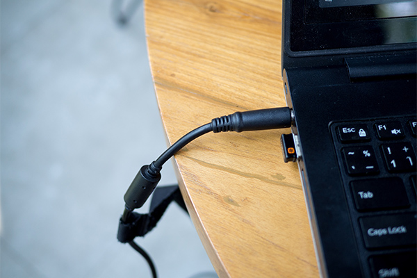 After the laptop is completely powered off, disconnect the AC adapter from the laptop.
If the laptop has a removable battery, remove it. If not, skip this step.